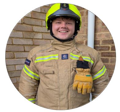 A smiling man in a firefighters uniform.