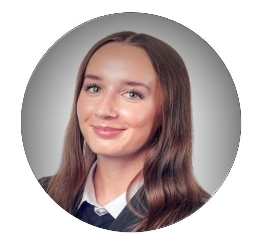 A girl smiling wearing school uniform