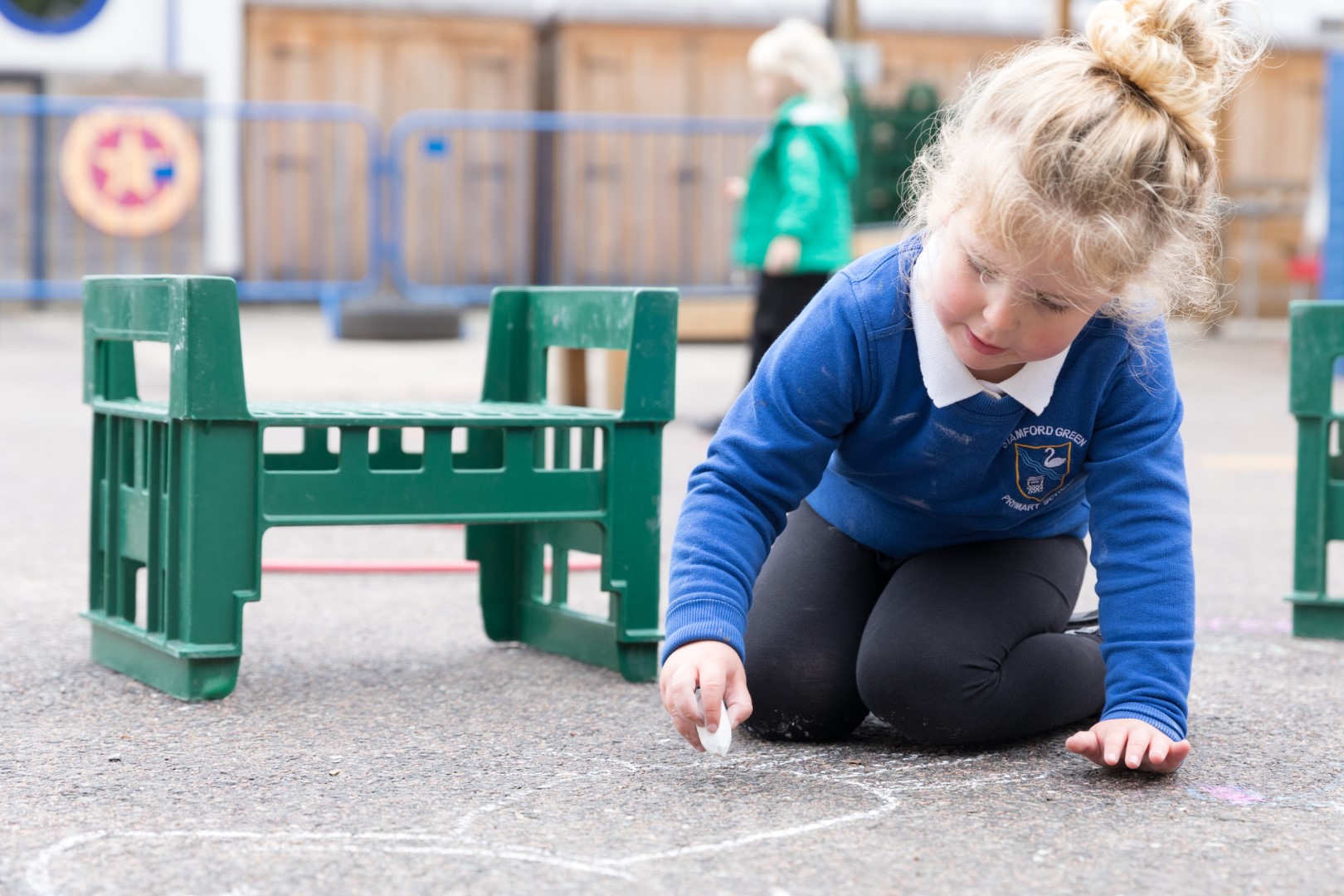Girl drawing on playground  with chalk